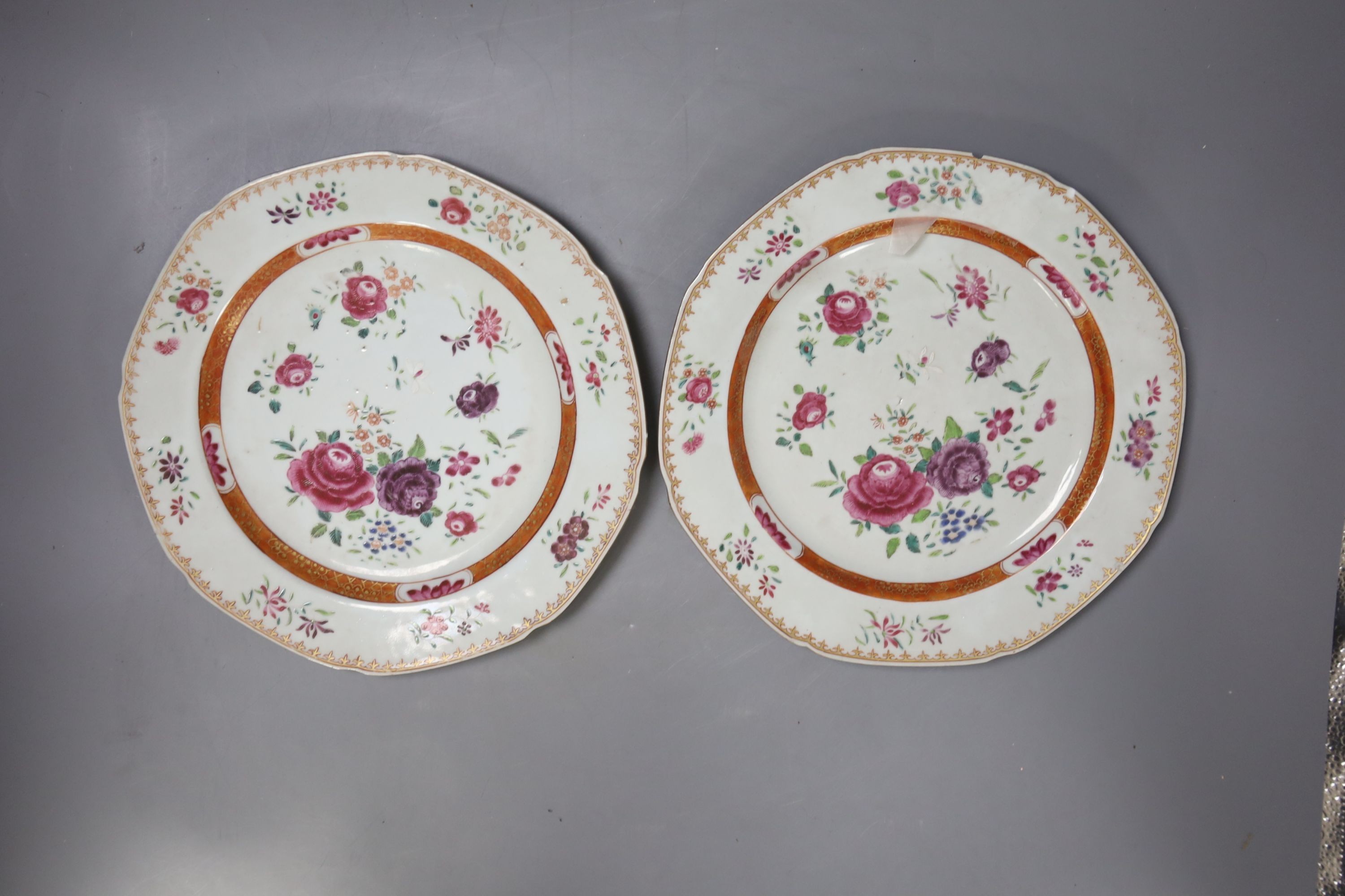 A pair of Chinese export porcelain famille rose octagonal plates, Qing Dynasty, Qianlong period, painted with scattered flowers, within a diaper pattern border